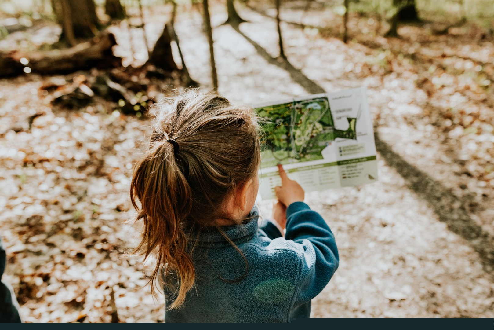 A kid shows a map of a theme park